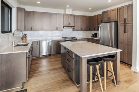 Well stocked kitchen with additional bar seating