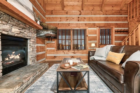 Open living space with queen sleeper sofa and loveseat to enjoy the gas fireplace and smart TV