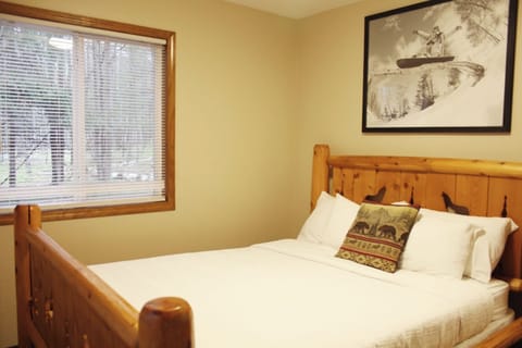 Sink into crisp linens and relax in warm, cabin-style serenity.