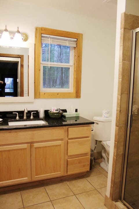 Refresh comfortably with a spacious vanity and glass shower.