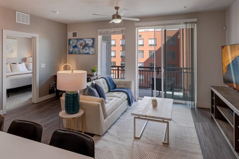 Beautifully designed living room. 75` TV, leather sofa and amazing views of mountains and city skyline.