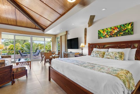 Wake up in your spacious island bedroom with vaulted bamboo ceilings and a carved wood bed. Step through the sliding glass doors to your private lanai surrounded by tropical greenery.
