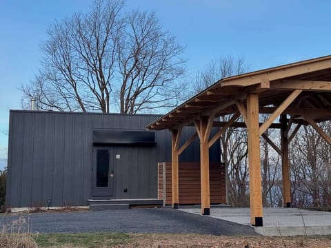 Front of Tradstuga with white oak and white pine post and beam car port