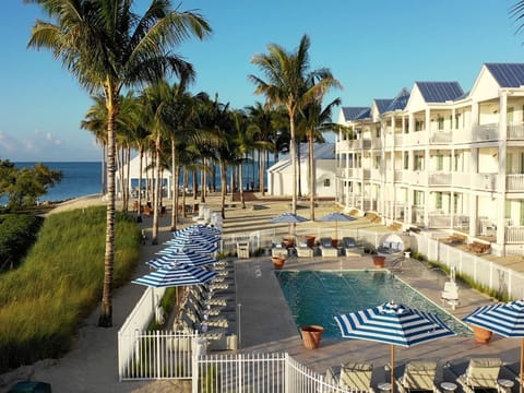 Vibrant poolside retreat overlooking the shoreline, designed for unwinding in sunlit comfort.