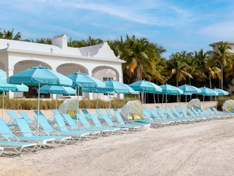 Steps away from the shore, this beachfront oasis pairs sandy serenity with cozy, shaded seating for ultimate relaxation.