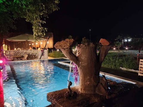Seasonal outdoor pool, open 8:30 AM to 9:00 PM, pool umbrellas