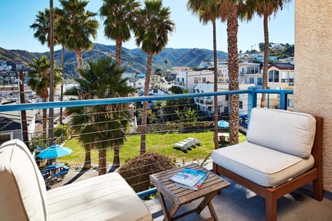 Sip morning coffee outside while palms sway below.