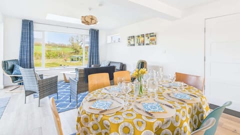 Enjoy family feasts at the large dining table, positioned perfectly to take in the garden views.