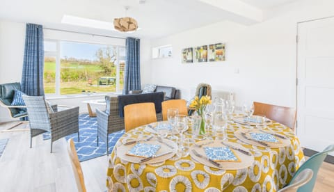 Enjoy family feasts at the large dining table, positioned perfectly to take in the garden views.