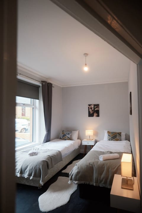 Cozy double bedroom with soft bedding and fresh towels provided.
Blackout curtains ensure a peaceful, uninterrupted night’s sleep.