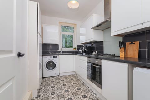 A stylish, fully equipped kitchen that combines practicality with a warm, welcoming atmosphere for all.