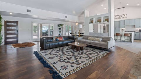 Open-layout living area with modern furnishings and wooden flooring