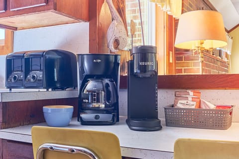 A coffee maker and complimentary coffee ready to brew. ☕🌅