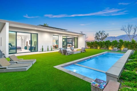 Your modern desert oasis awaits with a sparkling pool and mountain backdrop.