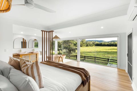 The luxurious main bedroom offers breathtaking countryside views from every angle