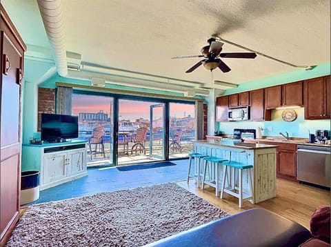 This bright and airy loft invites you to unwind with an open-concept layout, rustic coastal decor, and large sliding doors leading to a breathtaking waterfront patio. The fully equipped kitchen and spacious seating make it feel like home.