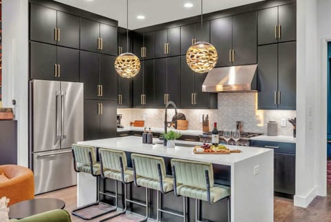 Savor culinary bliss in this chic downtown Nashville gourmet kitchen, perfect for entertaining with a sleek island and plush seating—ideal for unforgettable moments in your luxurious vacation rental.