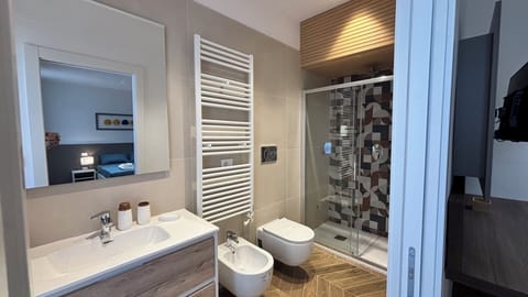 Deluxe Triple Room, Balcony, Partial Sea View | Bathroom | Shower, rainfall showerhead, hair dryer, towels
