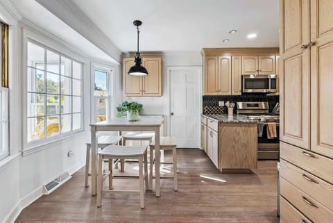 Bright and inviting kitchen with modern appliances and cozy dining — the perfect space to enjoy meals.