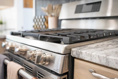 Modern kitchen with a stainless steel gas range, perfect for cooking up delicious meals.