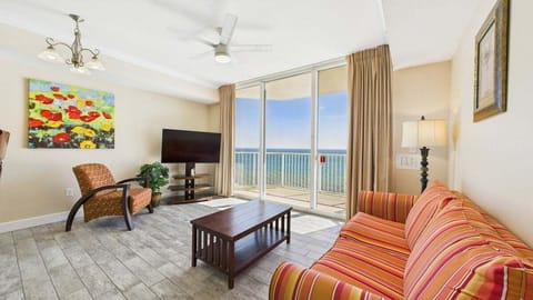 Open concept living area with TV sleeper sofa and gulf views