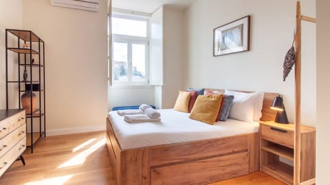 Unwind in a plush, sunlit bed with carefully curated décor that blends warmth and sophistication. #Bedroom #LovelyStay