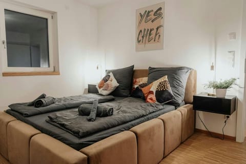 Sleep in style in this plush double bed surrounded by modern decor, soft lighting, and inspiring artwork.