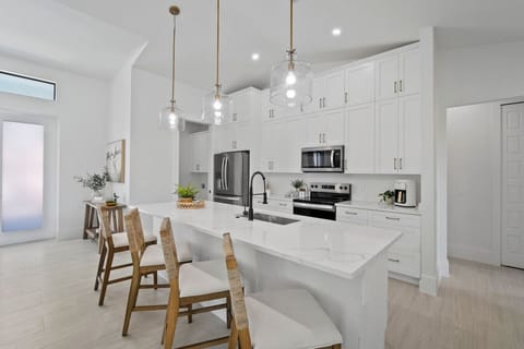 Spacious, modern kitchen with island seating for cooking and connection