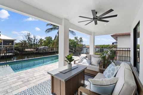 Lounge in the shade with pool views and the breeze off the bay