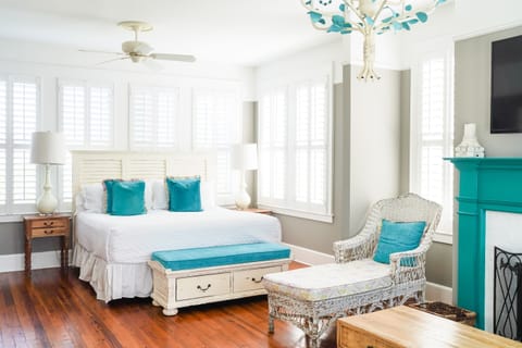 Private master suite with king bed, sitting area, and balcony