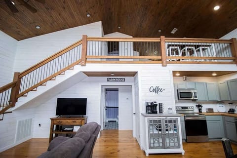 Open-concept living room with cozy seating, streaming-ready Smart TV with cable through Hulu Live, board games and a dedicated workspace—perfect for family gatherings.