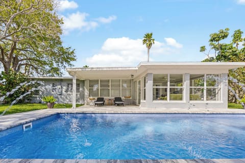 Relax by the poolside patio with modern outdoor seating and water features.