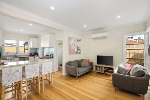 Open plan living and dining space with split system heating and cooling. 