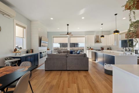 Full view of living space, with ocean views, full kitchen, and seating for your whole group.