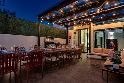 Rooftop terrace with cozy lounge seating and beautiful evening lighting