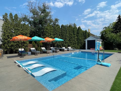 Saltwater Pool with Automatic cover, loungers, & outdoor living room and kitchen