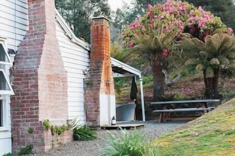 Fern's exterior, outdoor bath, outdoor shower and one of two outdoor dining areas.