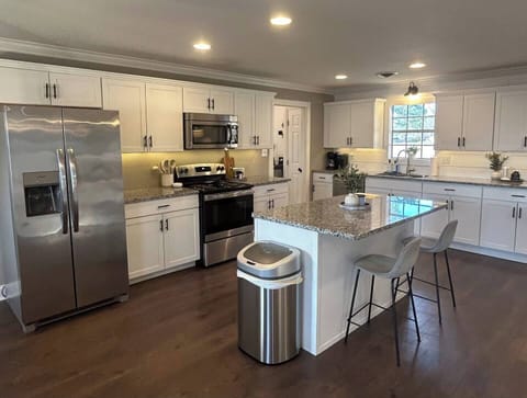 Spacious open-concept kitchen with a large island, perfect for cooking and gathering.