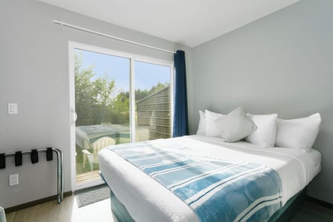 Comfortable bedroom filled with natural light and coastal charm