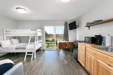 Open layout connecting kitchen, dining, and sleeping spaces