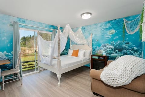 Bright coastal bedroom with ocean mural and soft, airy details