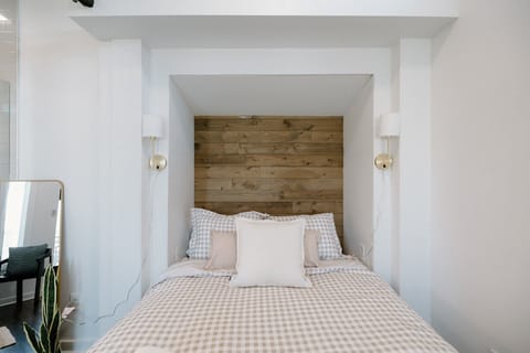 Upstairs bedroom retreat featuring a plush queen bed, coastal décor, and a peaceful atmosphere for a restful night after exploring Wrightsville or Carolina Beach