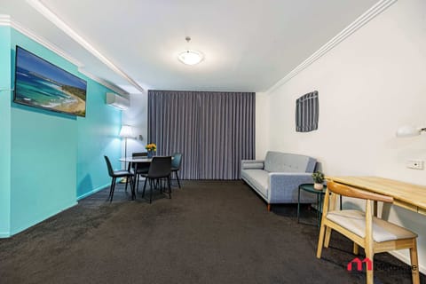 Spacious open-plan studio featuring a sofa bed, work desk, dining table, and access to a private balcony.