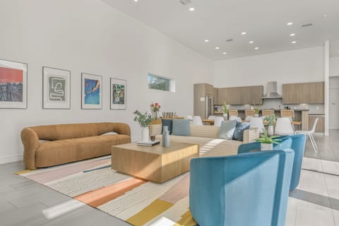 Bright, open living area with stylish décor and a spacious modern kitchen perfect for group gatherings. (Villa 4)