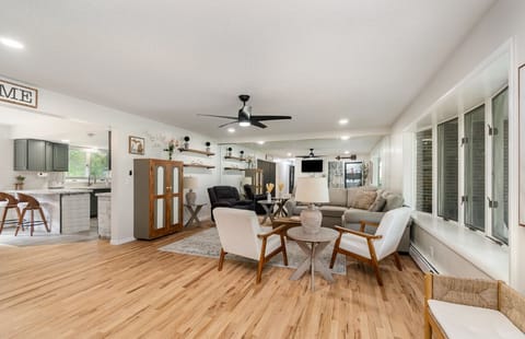Relax & socialize on comfortable seating in the bright and cheerful living room.