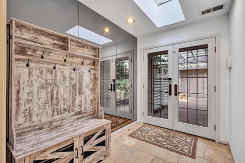 Architectural Elegance Meets Natural Beauty: Designed by Joe Hall, this exquisite courtyard house offers a seamless blend of luxury and nature, with sweeping marsh views and lush gardens surrounding every room.