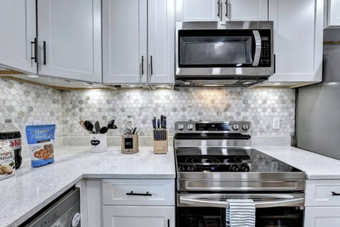 Electric oven, microwave, under counter lighting in kitchen