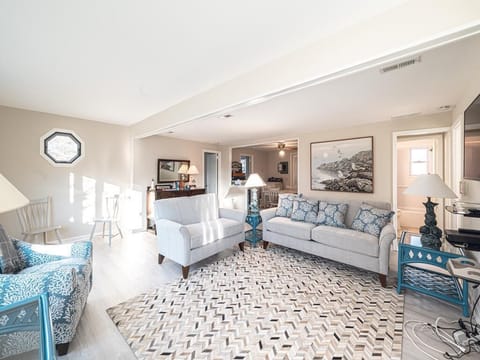The inviting living room, adorned with stylish new furniture, is the perfect place to gather and unwind.