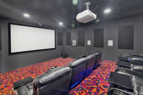 A big theater room with cozy seating to enjoy a movie night with family and friends.