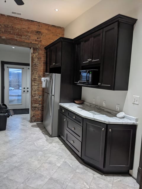 The kitchen open to the deck and the spiral staircase that goes to the garage